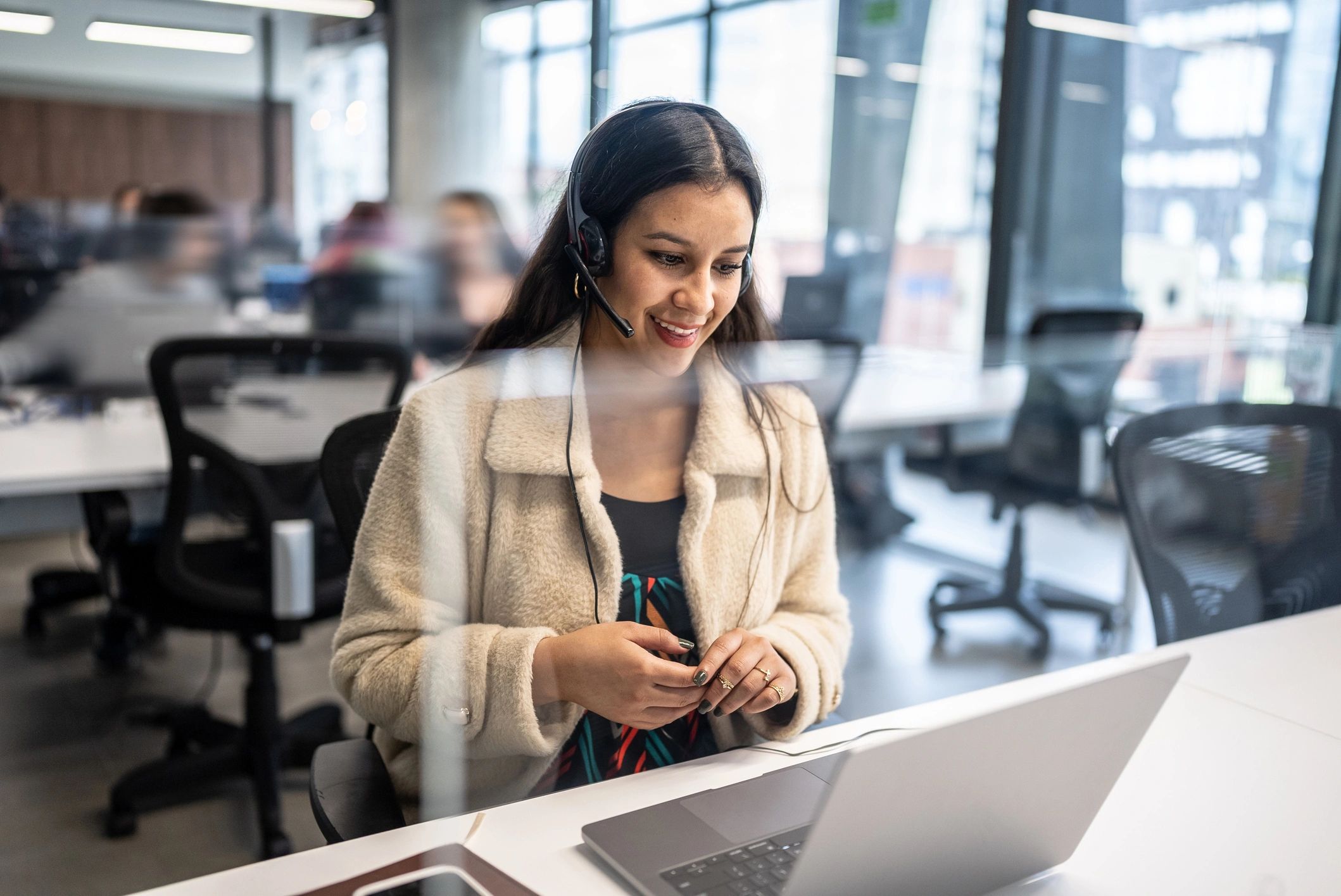 Customer support professional working at a laptop