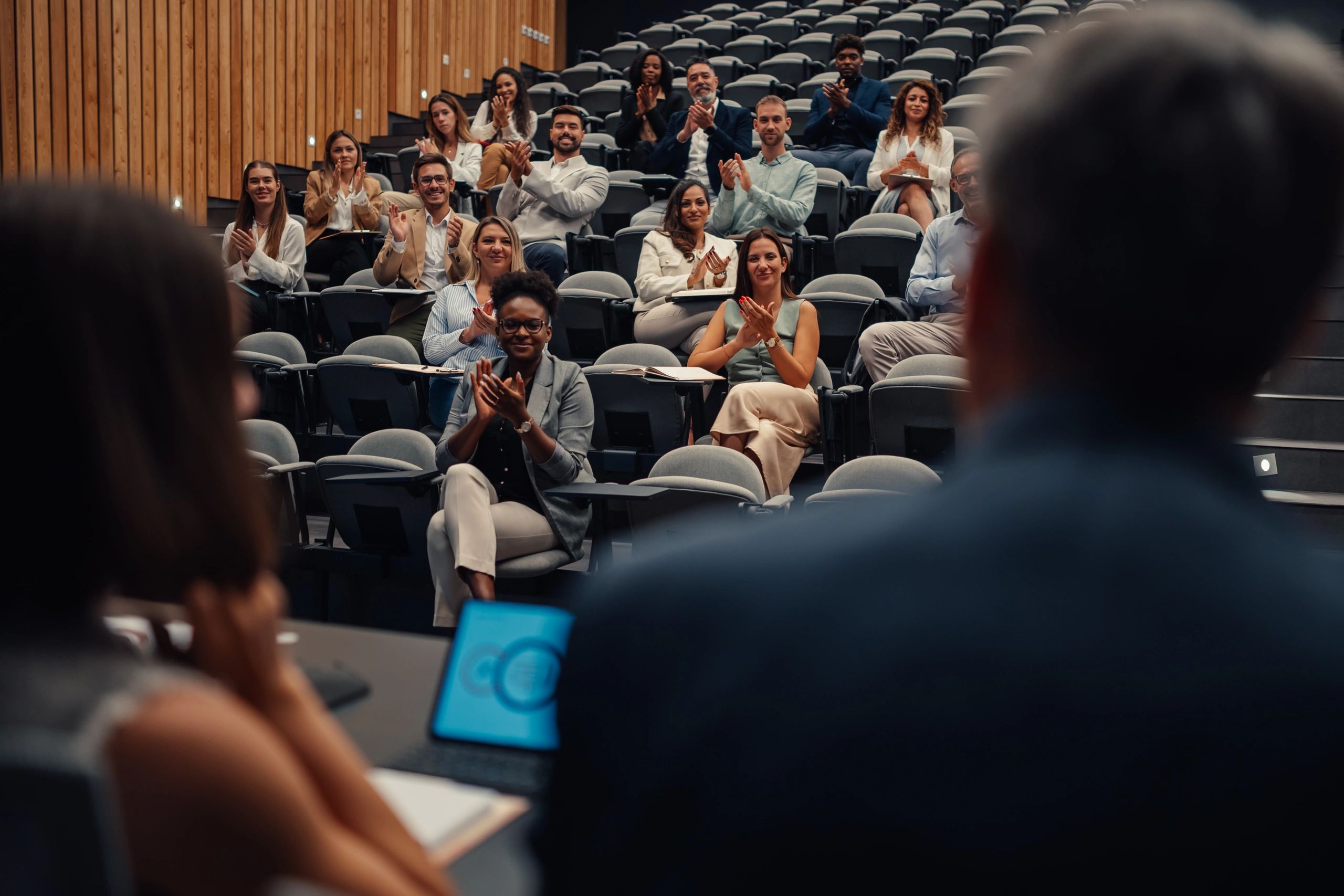 Audience applauding at a live conference event