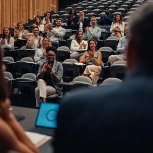 Business people applauding presentation at diversity conference